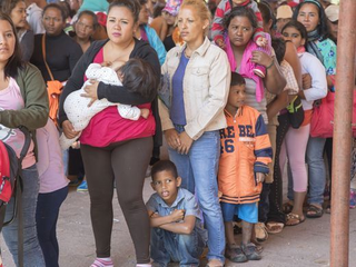 Central American migrants gathered inside and outside a church in Puebla, Mexico, on Saturday hoping to travel to the U.S. border